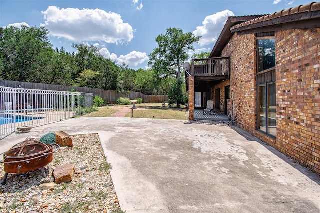 view of patio / terrace with an outdoor fire pit, a fenced backyard, and a fenced in pool