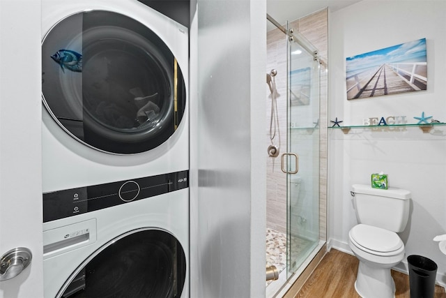 1900 Barton Springs Rd Unit 4040, Austin, TX 78704 - bathroom with estacked washer and dryer, a stall shower, and wood finished floors