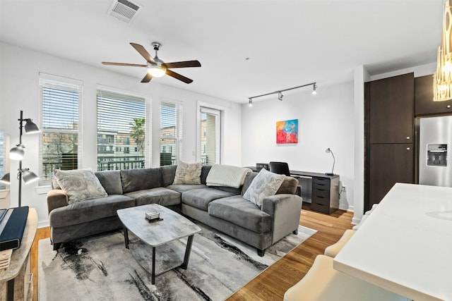 1900 Barton Springs Rd Unit 4040, Austin, TX 78704 - living room featuring rail lighting, a ceiling fan, and light wood-style floors