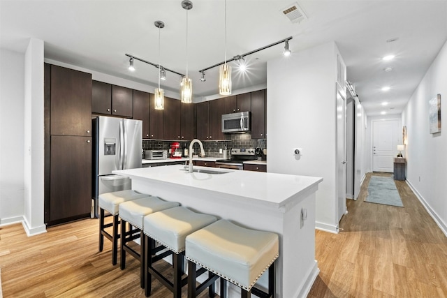 1900 Barton Springs Rd Unit 4040, Austin, TX 78704 - kitchen featuring stainless steel appliances, light countertops, light wood-style floors, and recessed lighting