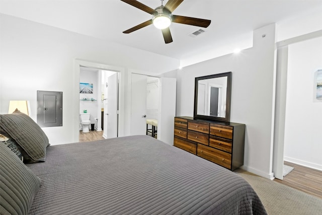 1900 Barton Springs Rd Unit 4040, Austin, TX 78704 - bedroom with electric panel, wood finished floors, ceiling fan, and ensuite bathroom