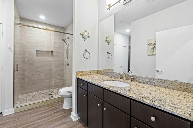 1900 Barton Springs Rd Unit 4040, Austin, TX 78704 - bathroom featuring wood finished floors, a stall shower, vanity, and recessed lighting