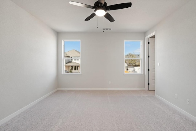 1205 N Roger Hanks Pkwy, Dripping Springs, TX 78620 - empty room with light colored carpet, visible vents, ceiling fan, and baseboards