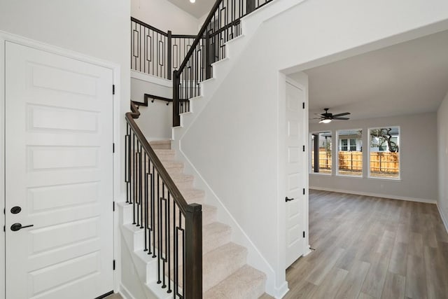 1205 N Roger Hanks Pkwy, Dripping Springs, TX 78620 - staircase with a towering ceiling, ceiling fan, baseboards, and wood finished floors
