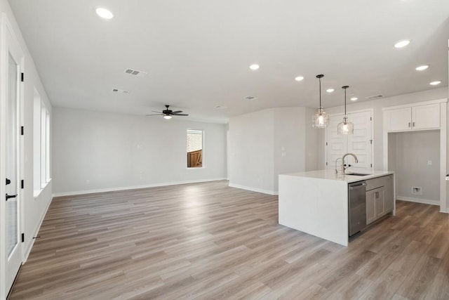 1205 N Roger Hanks Pkwy, Dripping Springs, TX 78620 - kitchen featuring decorative light fixtures, a center island with sink, light countertops, open floor plan, and dishwasher