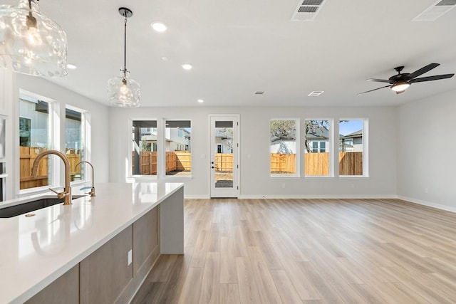 1205 N Roger Hanks Pkwy, Dripping Springs, TX 78620 - kitchen featuring visible vents, open floor plan, light countertops, and decorative light fixtures