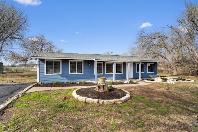 single story home featuring fence and a front lawn