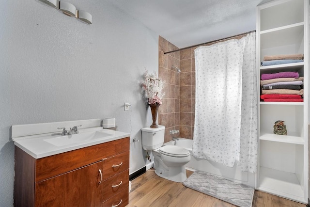 full bath featuring toilet, wood finished floors, vanity, and shower / tub combo with curtain