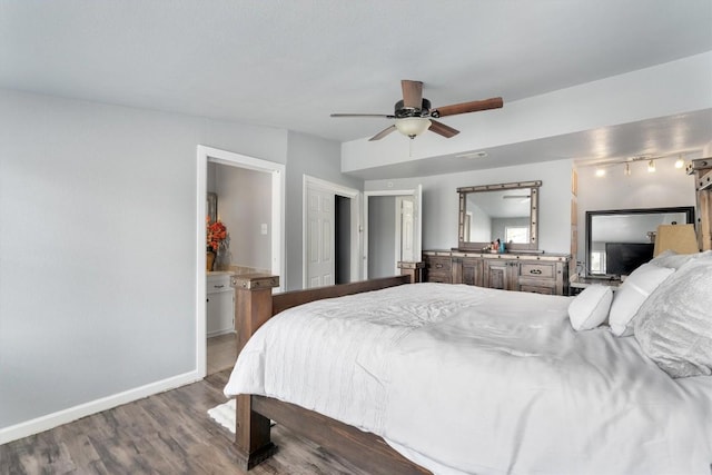 bedroom featuring ensuite bathroom, wood finished floors, a ceiling fan, and baseboards