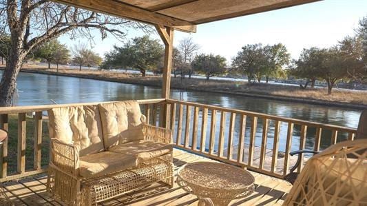 view of dock featuring a water view and an outdoor living space