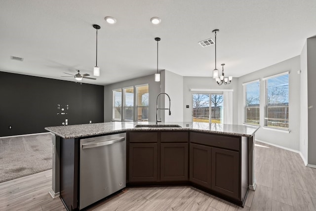 kitchen featuring a kitchen island with sink, a sink, visible vents, and stainless steel dishwasher