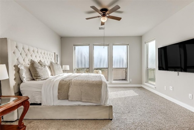 bedroom with a ceiling fan, carpet flooring, visible vents, and baseboards