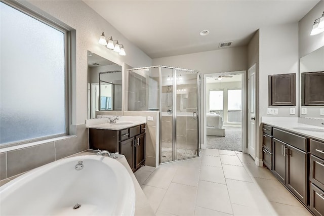 ensuite bathroom featuring two vanities, visible vents, ensuite bathroom, a sink, and tile patterned floors