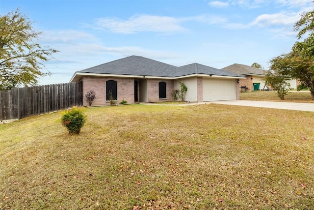 view of front of home with brick siding, an attached garage, a front yard, fence, and driveway