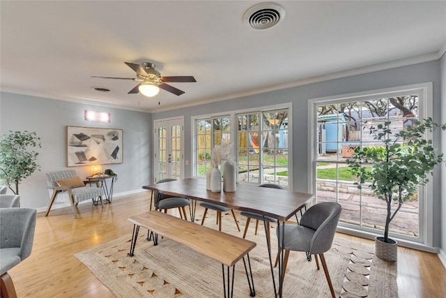 dining area featuring light wood-style flooring, visible vents, and baseboards