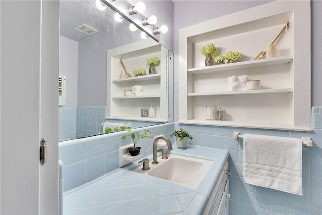 bathroom featuring built in shelves, visible vents, and vanity