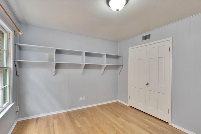 interior space with light wood-style floors, a closet, visible vents, and baseboards