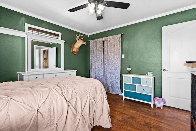 bedroom featuring a textured wall, dark wood-type flooring, a ceiling fan, and crown molding