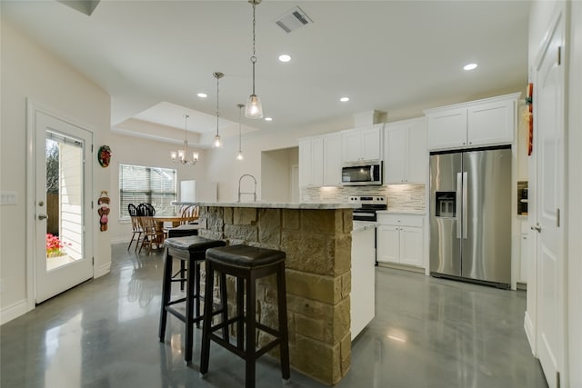 139 W Maple Dr, Marble Falls, TX 78654 - kitchen featuring appliances with stainless steel finishes, concrete flooring, backsplash, baseboards, and recessed lighting