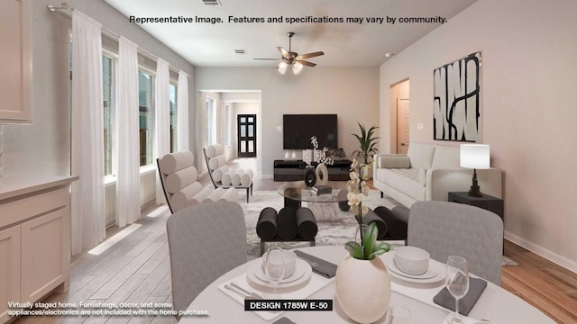 dining room featuring light wood finished floors, baseboards, visible vents, and a ceiling fan