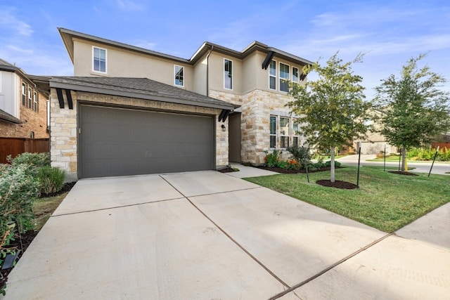 prairie-style house with stucco siding, stone siding, concrete driveway, and a front yard