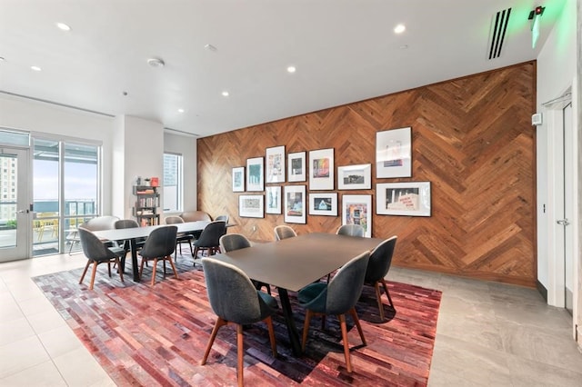 222 W Ave Unit 2403, Austin, TX 78701 - dining room featuring wooden walls, an accent wall, and recessed lighting