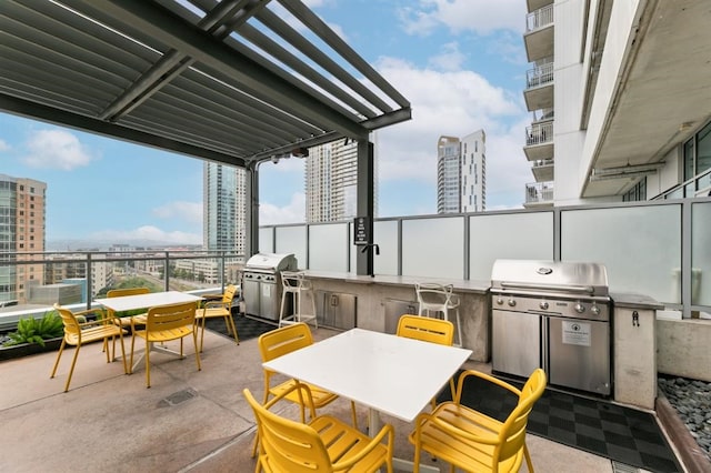 222 W Ave Unit 2403, Austin, TX 78701 - view of patio featuring outdoor dining area, a city view, and exterior kitchen