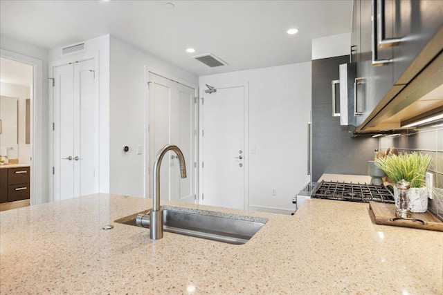 222 W Ave Unit 2403, Austin, TX 78701 - kitchen with light stone countertops, recessed lighting, and gas stove