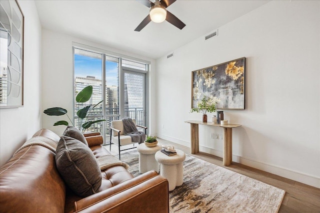 222 W Ave Unit 2403, Austin, TX 78701 - living room featuring a ceiling fan and wood finished floors