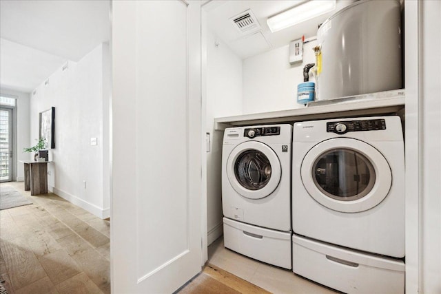 222 W Ave Unit 2403, Austin, TX 78701 - washroom featuring washer and clothes dryer and baseboards