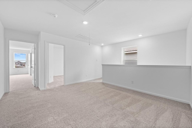 unfurnished room featuring attic access, recessed lighting, light colored carpet, and baseboards