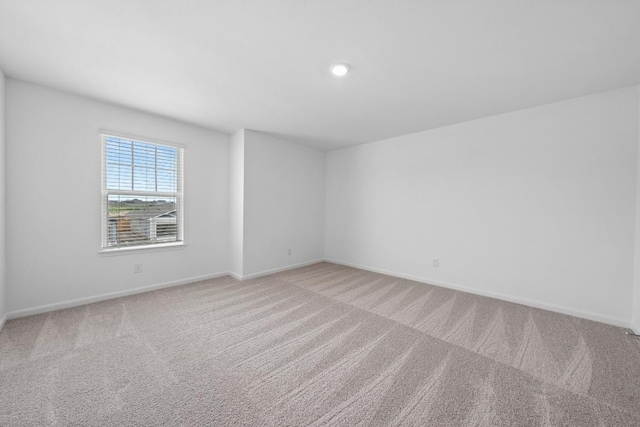 empty room with carpet flooring and baseboards