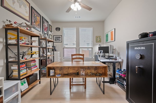 office space with light wood-style flooring, visible vents, and a ceiling fan