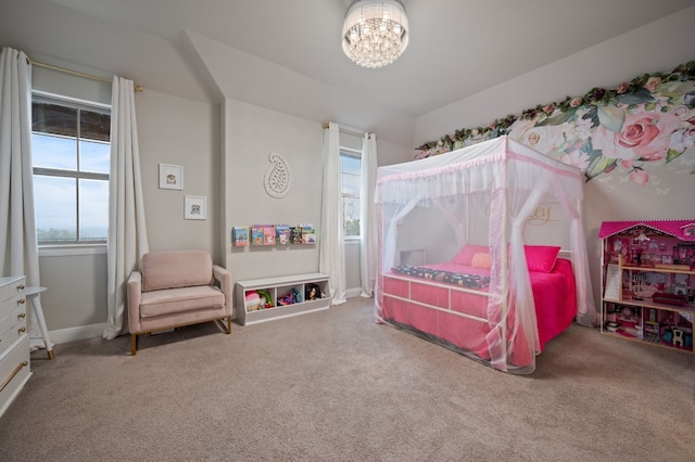 carpeted bedroom featuring multiple windows, baseboards, and an inviting chandelier