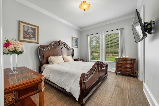bedroom with baseboards and crown molding