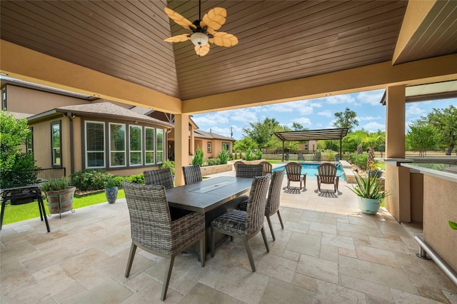 view of patio featuring a ceiling fan, outdoor dining area, and an outdoor pool