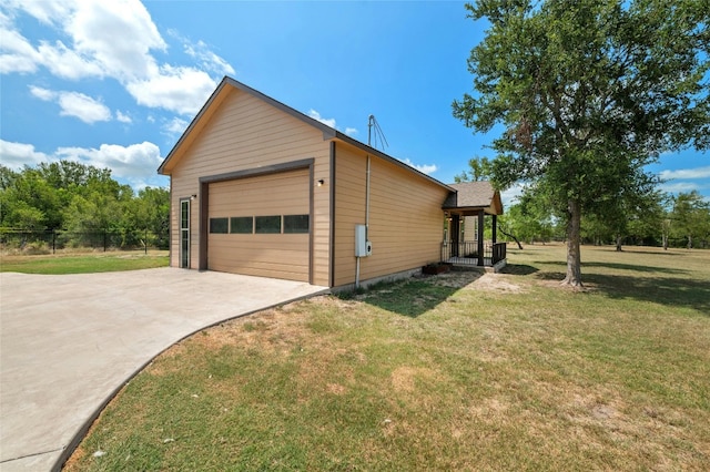 view of property exterior featuring fence, a porch, and a lawn