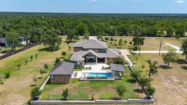 birds eye view of property featuring a wooded view