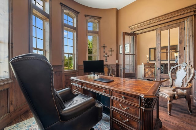 home office with wainscoting and wood finished floors