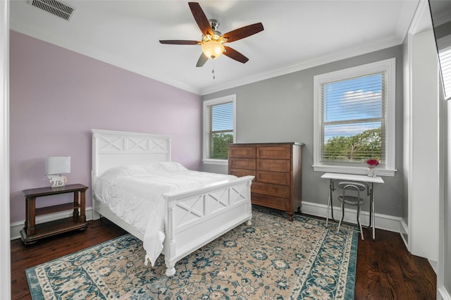 bedroom featuring dark wood-type flooring, visible vents, ornamental molding, and baseboards