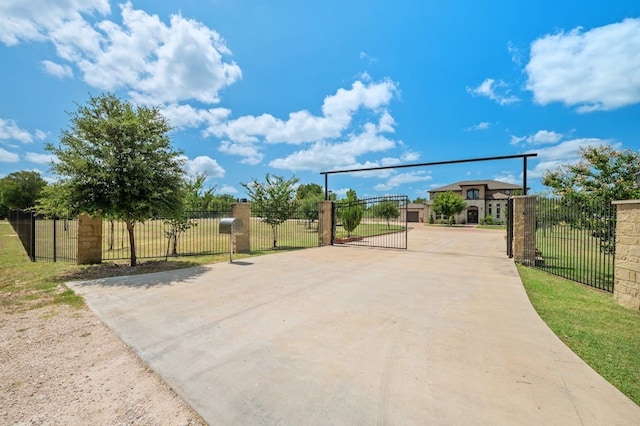 exterior space featuring a fenced front yard and a gate