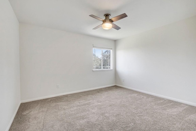 unfurnished room featuring ceiling fan, carpet, and baseboards