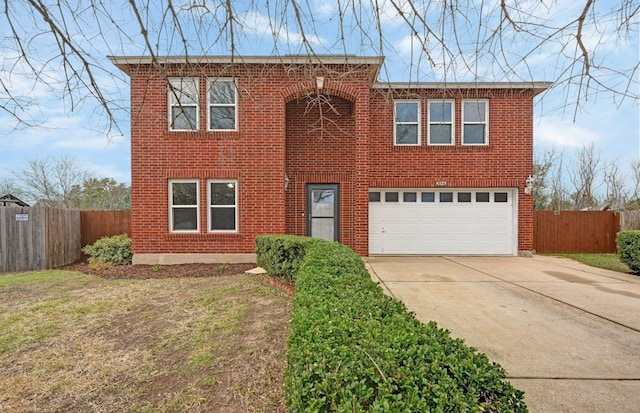 traditional home featuring a garage, driveway, brick siding, and fence