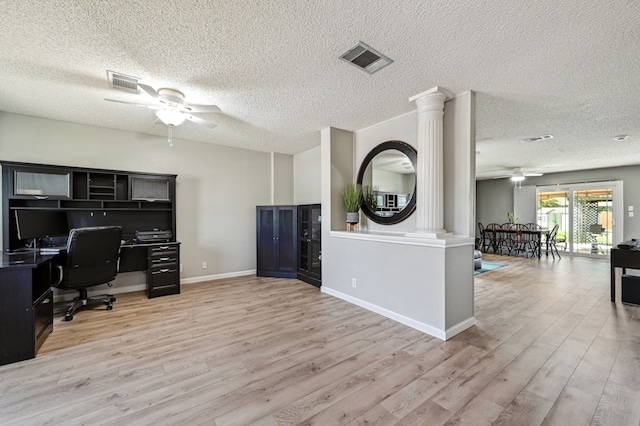 office space with light wood-type flooring, ceiling fan, and visible vents