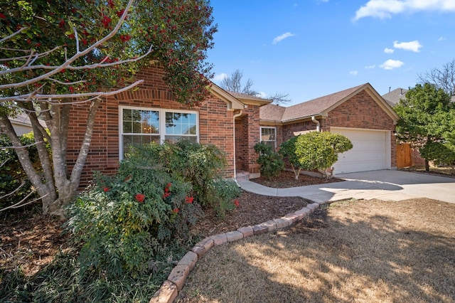 ranch-style home with a garage, driveway, and brick siding