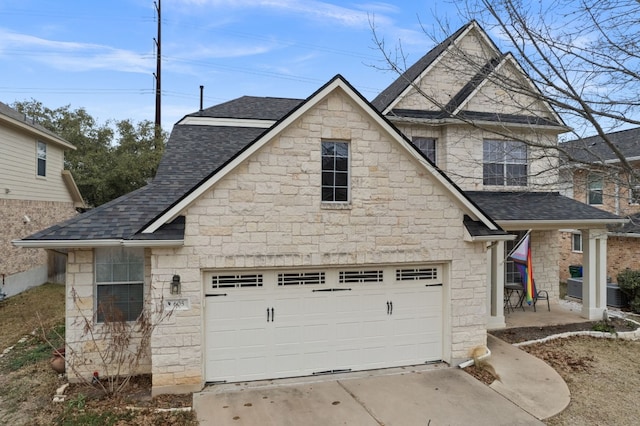 view of front of house with central air condition unit, a shingled roof, and concrete driveway