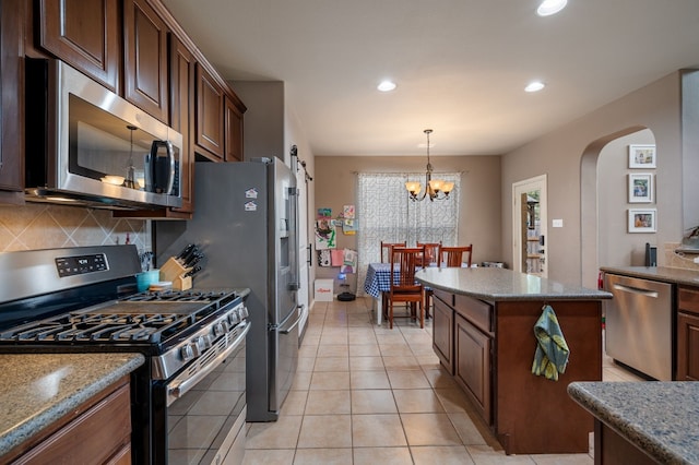 605 Hickory Run Dr, Cedar Park, TX 78613 - kitchen featuring appliances with stainless steel finishes, arched walkways, backsplash, recessed lighting, and pendant lighting