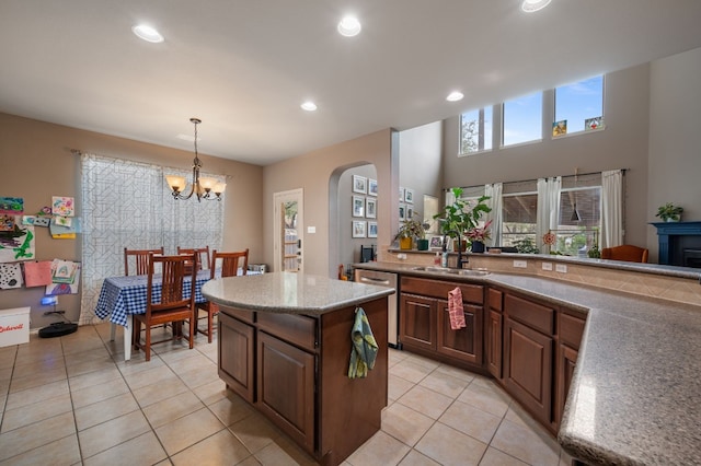 605 Hickory Run Dr, Cedar Park, TX 78613 - kitchen with dishwasher, arched walkways, light tile patterned floors, a chandelier, and a center island