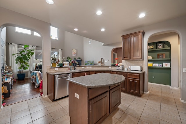 605 Hickory Run Dr, Cedar Park, TX 78613 - kitchen with dishwasher, a center island, light tile patterned flooring, recessed lighting, and arched walkways