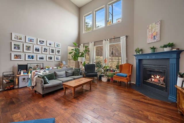 605 Hickory Run Dr, Cedar Park, TX 78613 - living area featuring a towering ceiling, wood-type flooring, and a tiled fireplace